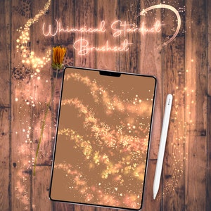May include: A digital tablet displaying a preview of a whimsical stardust brush set. The tablet is on a wooden surface with a dried flower stem and a white stylus.