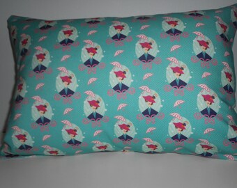 May include: A turquoise pillow with a repeating pattern of women wearing pink hats and holding umbrellas. The women are in a circle with a white background.