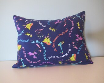 May include: A blue pillow with a repeating pattern of the text "Oh, the places you'll go!" and illustrations of characters from the book.