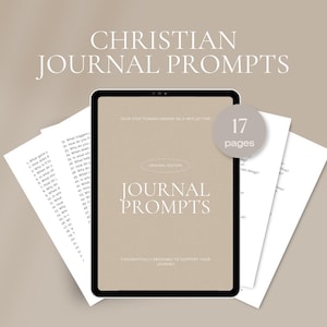 May include: A digital tablet displaying "Journal Prompts" with the text "Christian Journal Prompts" above. The tablet is surrounded by loose-leaf pages with numbered prompts. A circular graphic indicates 17 pages.