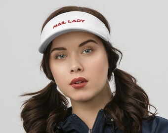 May include: A white visor with red embroidery that reads "MAIL LADY". The visor is worn by a person with brown hair styled in pigtails and wearing a navy blue jacket.