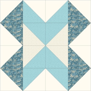 Puede incluir: Diseño de bloque de edredón con un patrón simétrico. Presenta tela floral verde azulado, triángulos azul claro y triángulos punteados blanquecinos, todo sobre un fondo crema. El bloque está dividido en nueve cuadrados.