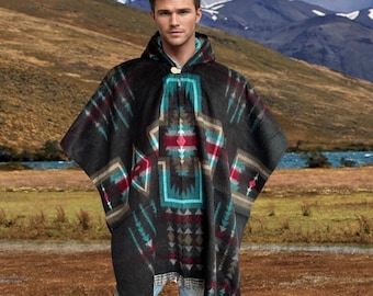 May include: A hooded poncho with a geometric pattern in shades of black, teal, red, and tan. The poncho has a button closure at the neck and a fringed hem. The background features a mountain range and a river.
