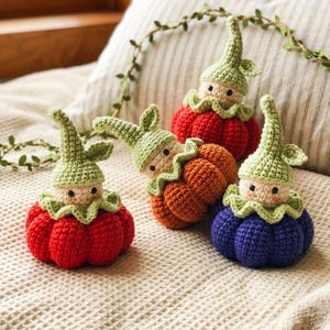 May include: Four handmade crochet gnome figures in red, orange, and blue. Each gnome has a green hat and a cream-colored face. The gnomes are sitting on a cream-colored textured surface.