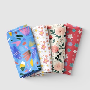 May include: Five fabric swatches with different patterns. The swatches are folded and arranged in a row. The patterns include abstract shapes, flowers, and geometric designs. The colors are bright and cheerful, including blue, pink, yellow, and green.