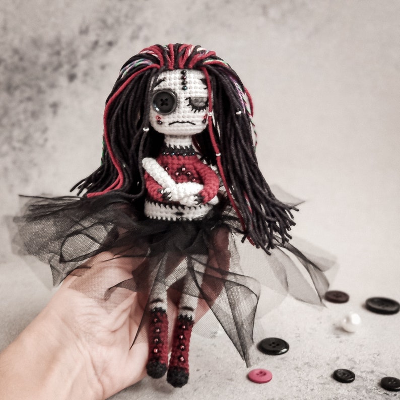 Crochet pattern for a handmade gothic amigurumi doll, ideal for horror lovers, featuring a spooky stitched face and dramatic outfit.