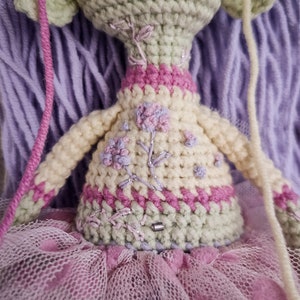 Close-up of a Gothic amigurumi doll, featuring a unique voodoo-inspired design with detailed stitching.