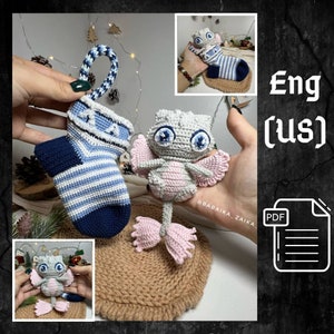 May include: Crochet pattern for a cute, pink and gray dragon with big blue eyes. The pattern is available in English (US) and includes a PDF download.