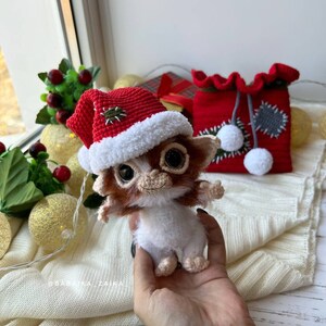 Gizmo Christmas toy in red festive bag, ideal for holiday home decor and as a unique, eco-friendly gift.