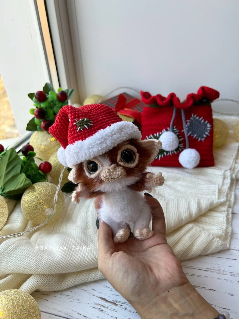Gizmo Christmas toy in red festive bag, ideal for holiday home decor and as a unique, eco-friendly gift.
