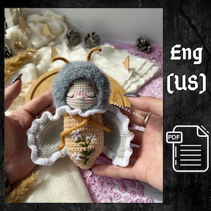 Handmade amigurumi butterfly baby doll crafted with eco-friendly yarn. This unique crochet pattern is perfect for DIY enthusiasts looking to create a soft toy with love. Ideal as a thoughtful and personal gift for birthdays, baby showers, or just as a charming decor piece for a child's room.