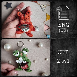 May include: A set of two crocheted amigurumi keychains. One keychain features a green frog holding a fly, and the other keychain features an orange cat holding a fish. The keychains are both made with colorful yarn and have detailed features. The image also includes the text "SET 2 in 1" and "ENG (US)" indicating the language of the instructions.