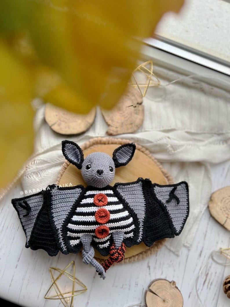 Amigurumi Halloween bat with striped belly and wings, spooky crochet plush pattern for DIY decor and gifts.