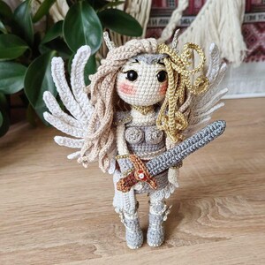 Back view showing detachable crocheted angel wings on viking doll