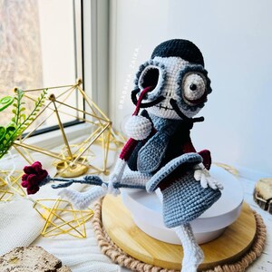 Close-up of crochet Mr. Santa Muerte highlighting detailed embroidery and skeleton-style features, great for Halloween themes.