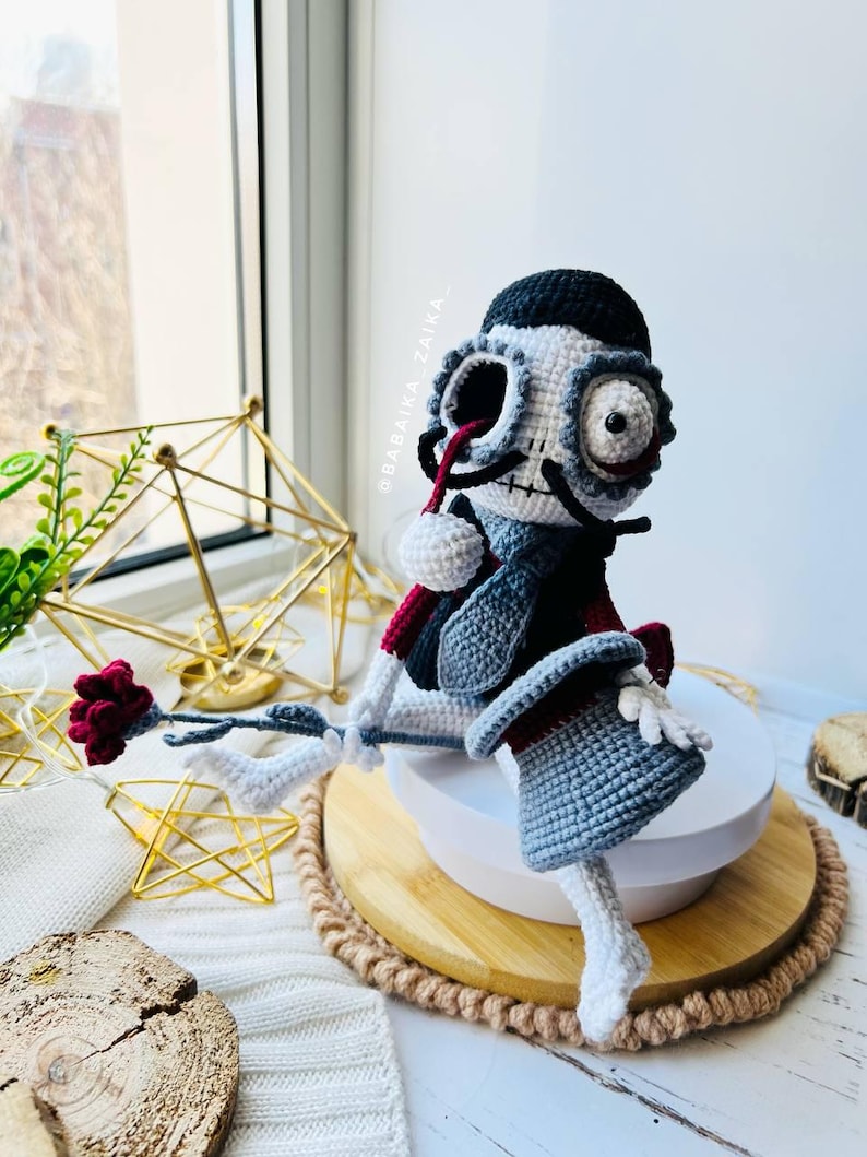 Close-up of crochet Mr. Santa Muerte highlighting detailed embroidery and skeleton-style features, great for Halloween themes.