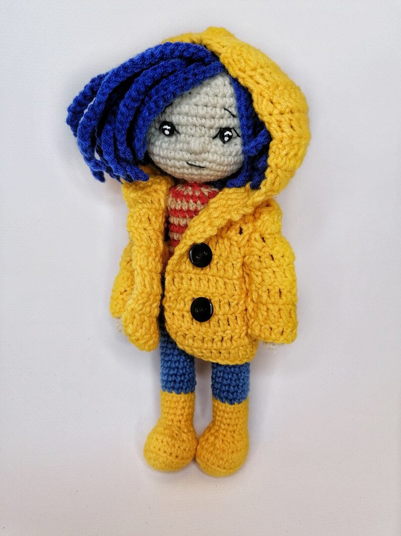 A side-by-side image of the Coraline doll and the voodoo bunny, illustrating the size comparison between the two handmade crochet toys.