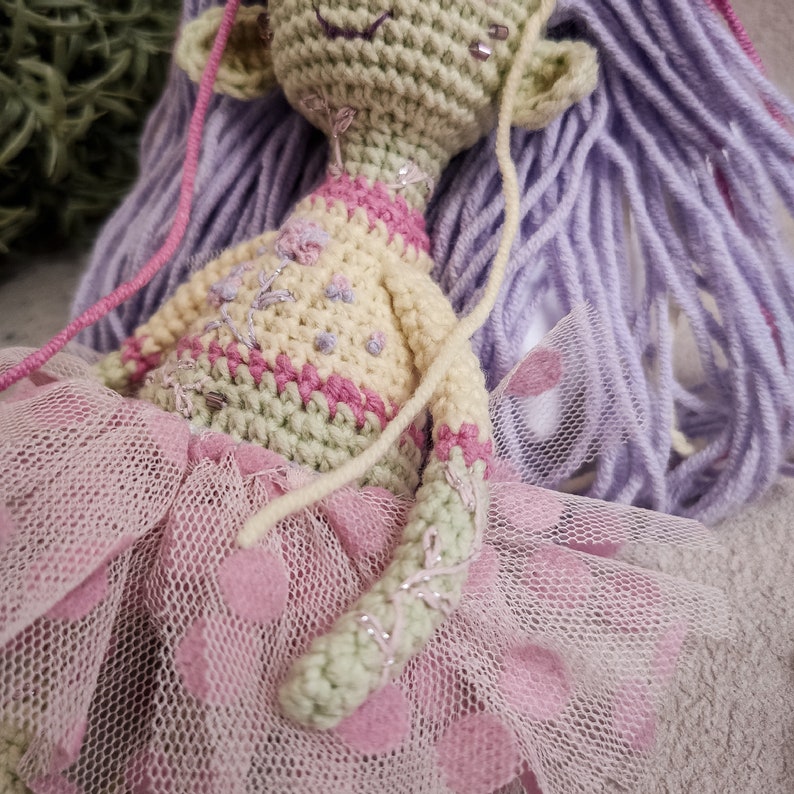 Soft and eerie Gothic crochet doll with delicate yarn details, perfect as a handmade keepsake or decor.