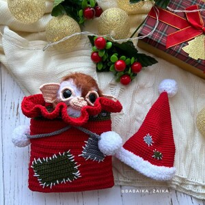 Amigurumi Gizmo with Christmas bag and hat, handcrafted for a unique holiday gift, collectible crochet toy.
