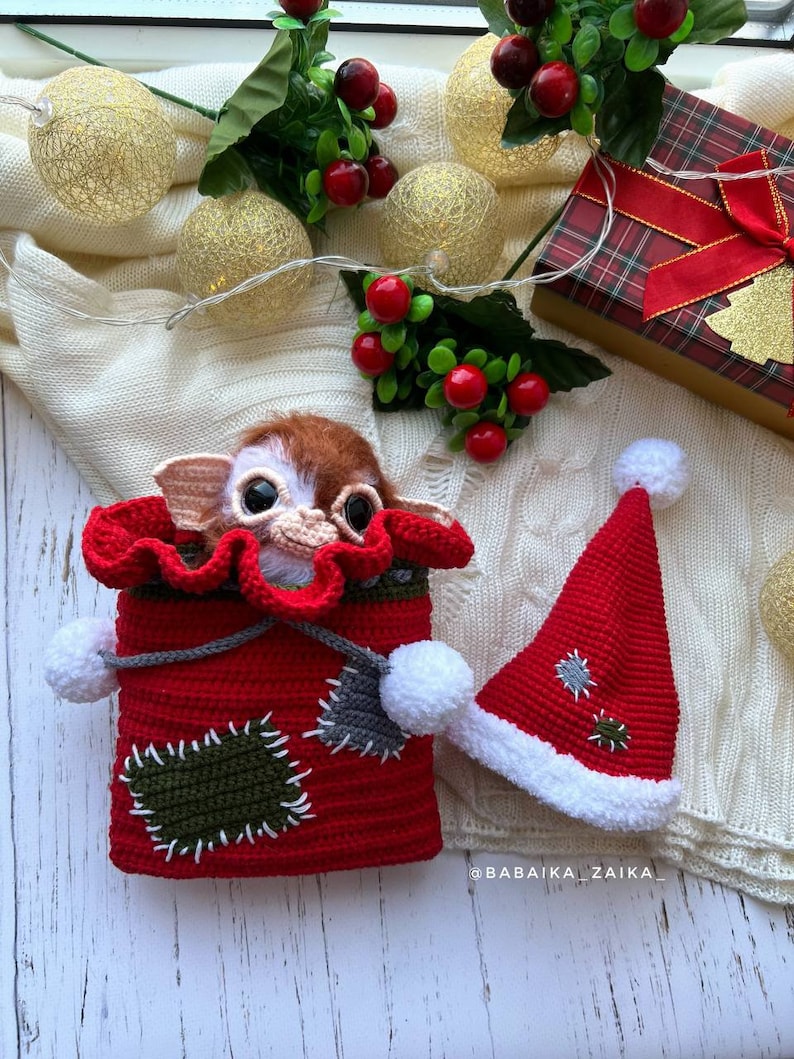 Amigurumi Gizmo with Christmas bag and hat, handcrafted for a unique holiday gift, collectible crochet toy.
