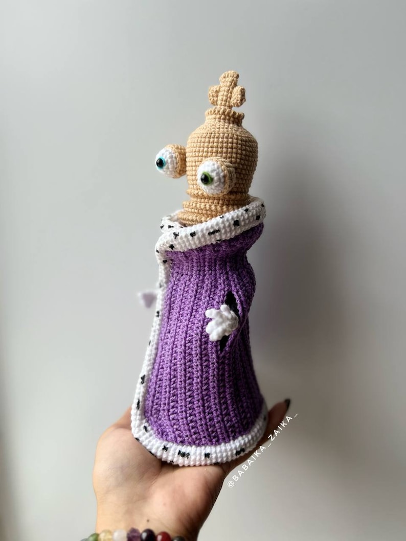 Handmade crochet Kinger figure posed for a creative photo shoot, emphasizing its unique design and festive appeal.