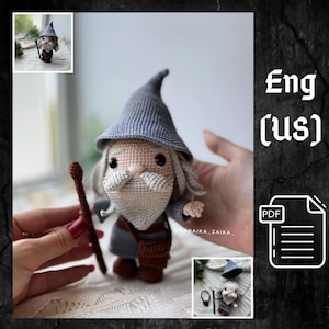 May include: A crocheted wizard doll with a gray hat, long white beard, and a brown staff. The doll has a gray and blue outfit and is held in a person's hands. The image includes the text "Eng (us)" and a PDF icon.