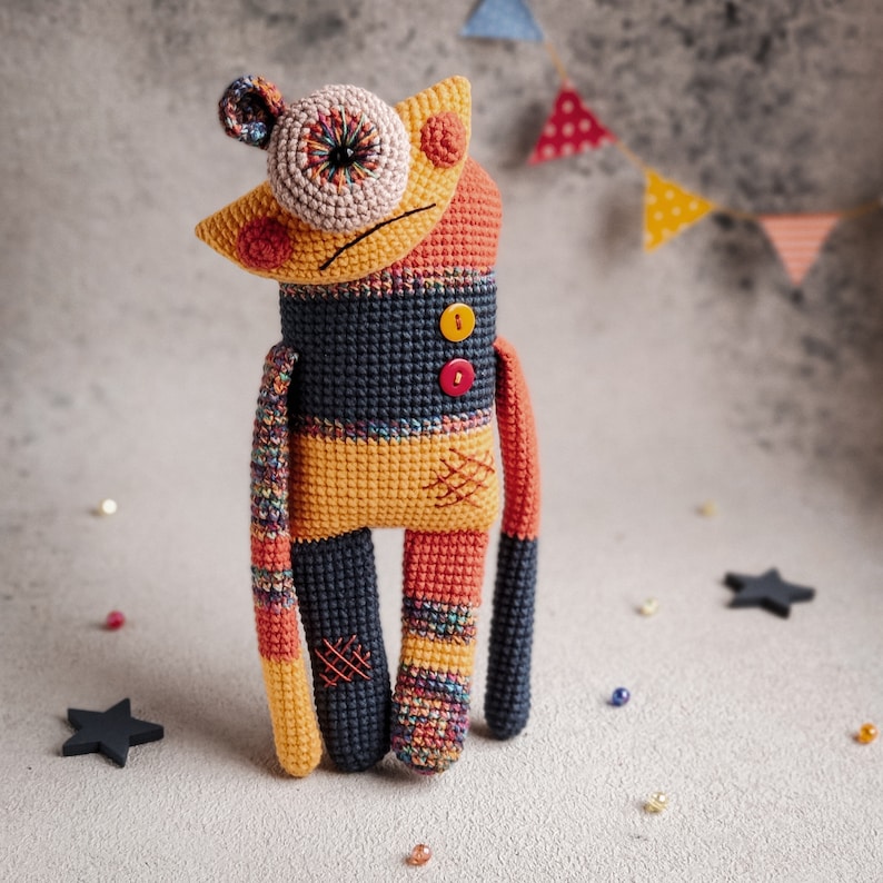 Handmade crochet monster Mr. Lu-Lu, perfect for Halloween or as a quirky decor item for unique collections.
Close-up of the button detailing on Mr. Lu-Lu, showcasing the unique craftsmanship of the crochet pattern.
