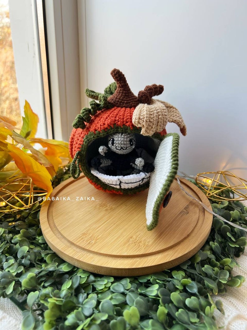 Detailed side view of a handmade amigurumi pumpkin house with a cute crochet spider. Unique design for Halloween decor. Digital pattern for DIY lovers.