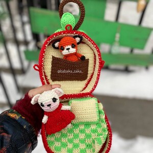 Two adorable crochet foxes nestled inside an apple-shaped bag. Digital PDF pattern for crafting personalized, handmade toys.