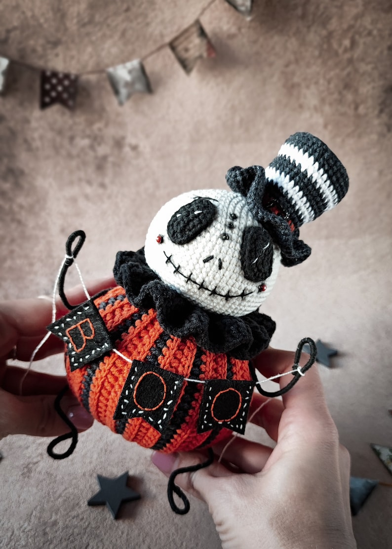 A dramatic angle of the Jack pumpkin figure, capturing the essence of a spooky yet playful Halloween character. The vibrant orange crochet dress contrasts beautifully with the darker elements.