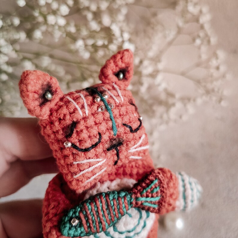 Rear view of a handmade crochet cat toy, showing detailed stitches. This unique handmade gift is perfect for birthdays or special occasions.