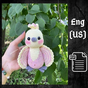 May include: Crochet amigurumi pattern for a pink and white bird with a grey beak and black eyes. The pattern is available in English (US) and is in PDF format.