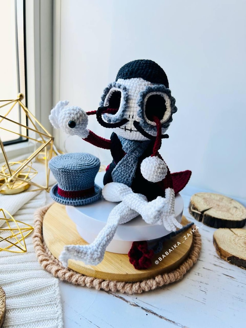 Detailed view of Mr. Santa Muerte amigurumi holding a red crochet rose, ideal for Halloween ornament collection.