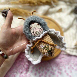 Close-up of the crochet process creating an adorable amigurumi butterfly baby doll. The pattern is designed for easy DIY crafting, making it a heartfelt gift idea and a creative project that adds joy and warmth to your handmade collection.