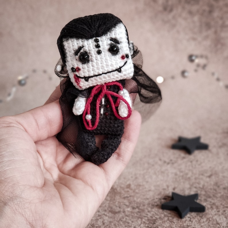 Two crochet vampire dolls in hand – craft heartwarming handmade gifts with this easy PDF tutorial. Perfect for creating personalized toys that will be cherished forever.