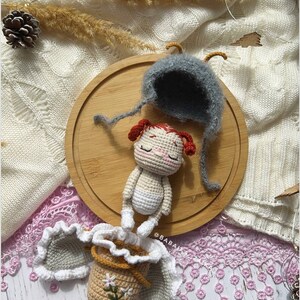 A hand holding the completed butterfly doll, symbolizing the love and care put into every handmade creation. This crochet pattern is perfect for creating a heartfelt gift or cherished keepsake.