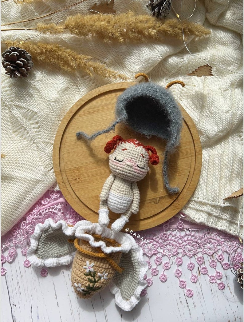 A hand holding the completed butterfly doll, symbolizing the love and care put into every handmade creation. This crochet pattern is perfect for creating a heartfelt gift or cherished keepsake.