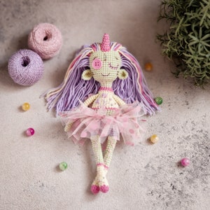 A voodoo-style crochet doll with stitched button eyes, a great Halloween amigurumi project for beginners.