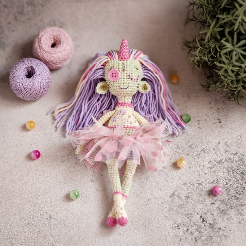 A voodoo-style crochet doll with stitched button eyes, a great Halloween amigurumi project for beginners.