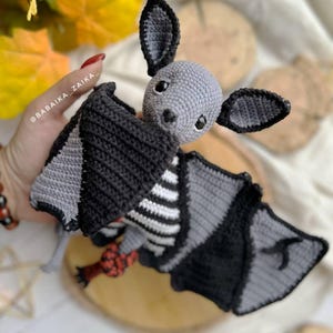 Crochet Halloween bat plush on autumn leaves, printable amigurumi pattern, easy PDF for beginners.