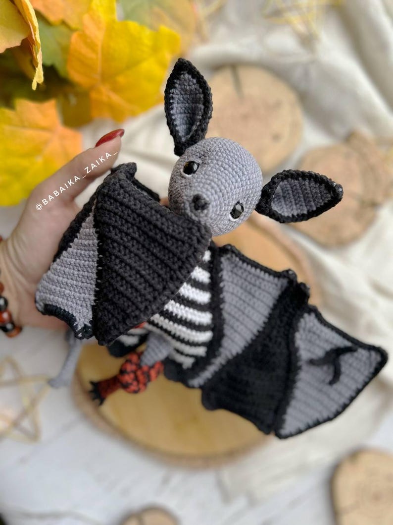 Crochet Halloween bat plush on autumn leaves, printable amigurumi pattern, easy PDF for beginners.