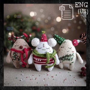 May include: Three crocheted Christmas decorations, each with a different design. The first is a reindeer with brown fur, red antlers, and a red scarf. The second is a white bear with a green and red jumper and a white scarf. The third is a white snowman with a green hat and a green scarf. All three decorations have a festive Christmas theme.