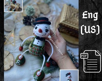 May include: A handmade crochet snowman doll with a black top hat, bow tie, and plaid overalls. The snowman has a carrot nose, rosy cheeks, and green shoes. The doll is approximately 5 inches tall.