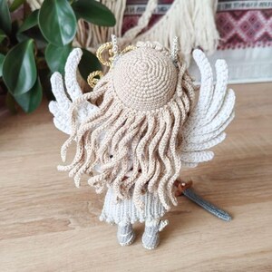 Finished warrior doll posed in forest-style decor with dried foliage