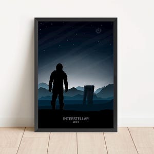 May include: A black and white poster with a silhouette of an astronaut standing on a desolate planet. The text "Interstellar 2014" is at the bottom of the poster.