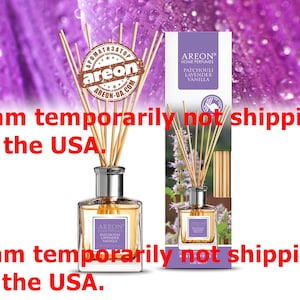 May include: An Areon home perfume diffuser with patchouli lavender vanilla fragrance. The square glass bottle has a silver neck and is filled with a light amber liquid. The product includes a box with the same design and a bundle of wooden reeds.