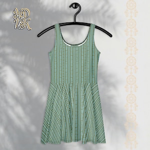 May include: A sleeveless skater dress with a green and blue vertical pattern, hanging on a black hanger. The dress features a scoop neckline and a flared skirt. The dress is displayed against a white background with a shadow.