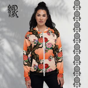 May include: A peach-colored bomber jacket with a floral design featuring red and pink roses, black branches, and a white zipper. The jacket has the text "MD UK" on the upper left side.