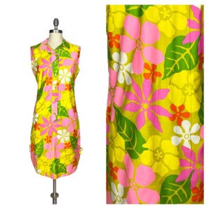 May include: A sleeveless dress with a yellow background and a large floral print in pink, white, and orange. The dress has a collared neckline and button closure.