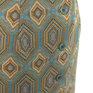 May include: A blue and brown skirt with a geometric pattern and button closures.